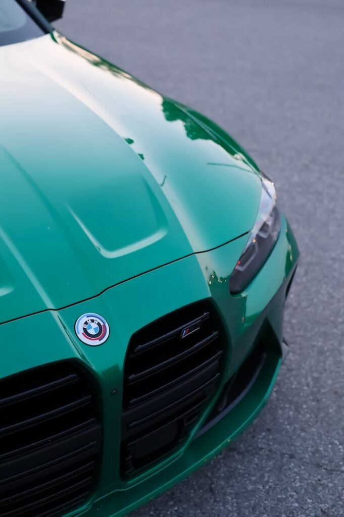 Sleek green sports car bonnet with a focus on luxury and design.